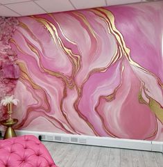 a pink and gold painted wall in a living room