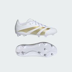 a white and gold soccer shoe next to it's soles on a white background