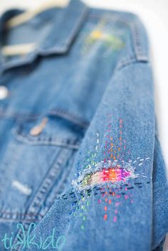 an old jean jacket with colorful sprinkles painted on the front and back