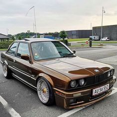 a brown car parked in a parking lot