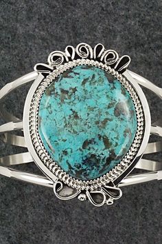 This stunning turquoise and sterling silver bracelet was made by Navajo silversmith Leslie Nez. The back is signed Leslie Nez and Sterling.Size: 5 1/2" (will fit up to a 6 5/8" wrist)Gap: 1 1/8"Length: 2 1/4"Width: 1 3/4"Free shipping on all orders! We ship with USPS and always include tracking. All orders ship within a day of payment.Returns are accepted up to 30 days after you receive your order. Just send us a message. Our shop offers cash back or store credit. The item must be returned in ne Elegant Sterling Silver Bracelet With Turquoise, Bohemian Sterling Silver Oval Cuff Bracelet, Bohemian Oval Sterling Silver Cuff Bracelet, Handmade Turquoise Oval Sterling Silver Bracelet, Handmade Turquoise Sterling Silver Oval Bracelet, Handmade Oval Turquoise Sterling Silver Bracelet, Southwestern Oval Sterling Silver Cuff Bracelet, Oval Southwestern Sterling Silver Cuff Bracelet, Southwestern Style Oval Sterling Silver Cuff Bracelet