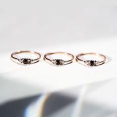 three rings sitting on top of a white surface