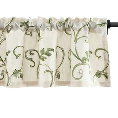 an embroidered curtain with vines and leaves on it