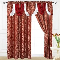 a red and white curtain in front of a window with curtains hanging on the side