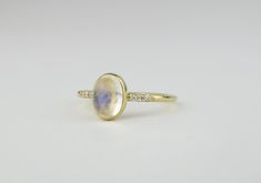 Iridescent, soothing and beautiful. This rainbow moonstone ring is made from 14k solid gold or 14k solid white gold material. Set with a natural rainbow moonstone and three genuine diamonds on each side. Whether you're buying this beautiful moonstone ring as a gift or for yourself, it will help with inter growth and strength and bring forth new beginnings and inspiration. Handmade in Los Angeles, CA! Each stone is unique and there may be slight color and height differences. We handpick the most Thick Gold Band, Thick Gold Ring, Gold Moonstone Ring, Thick Ring, Gold Rings Simple, Rainbow Moonstone Ring, Gold Filled Ring, Solid Gold Rings, Solid Gold Jewelry