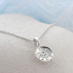 Our Wonderful Sterling Silver Bubble Dish Necklace uses a beautiful abstract design to create a truly interesting piece of jewellery . This gorgeous sterling silver necklace is perfect for people who like their jewellery with extra design and flare. This necklace can be made even more personal by the addition of some initial letter charms or a key and pearl combination. Why not complete the set with our matching sterling silver swirling waves earrings. All Martha Jackson jewellery comes complete with a gift box and blank gift card for you to write a short message on  Made from: Sterling silver Dimensions Pendant/earring diameter 1.9cm available on either a 40-45cm, 50cm or 61cm belcher chain. Add on key charm 1.3x0.5cm. Letter charms vary in size from 1cm to 1.5cm long. Sterling Silver Drop Necklace With Large Pendant, Nickel-free Drop Sterling Silver Necklace, Sterling Silver Drop Necklace Nickel Free, Sterling Silver Drop Necklaces, Sterling Silver Drop Necklace With Polished Finish, Unique Silver Drop Necklaces, Unique Silver Drop Necklace, Modern Sterling Silver Necklace In Silver, Drop White Gold Sterling Silver Necklaces