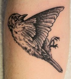 a small bird tattoo on the leg