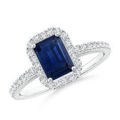 a blue sapphire and diamond ring on a white background