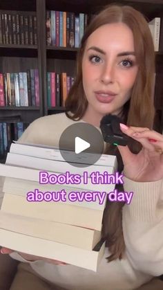 a woman is holding books in front of her face and the caption reads books i think about every day