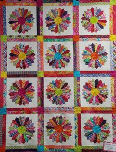 a colorful quilt with many different designs on it