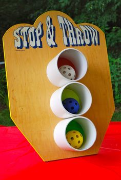 a wooden board with three different colored dices in it and the words stop & throw above them