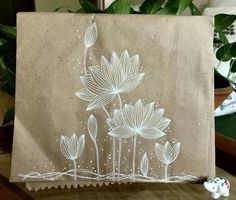 a piece of brown paper with white flowers on it