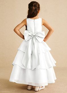 Sweetums is our elegant matte satin and organza flower girl dress. Her V-neckline is complimented with a clean bodice and a thin belt that wraps around to a bow back detail. The three-tier A-line skirt creates a beautiful, flowing silhouette, ideal for twirling. Organza Flower Girl Dress, Ivory Flower Girl, Ivory Flower Girl Dresses, White Flower Girl Dresses, Ivory Flowers, Three Tier, Bow Back, Matte Satin, A Princess