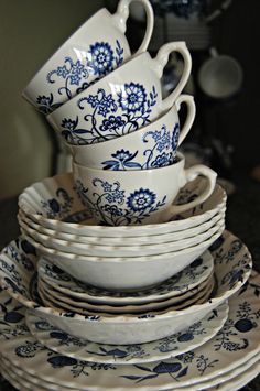 a stack of blue and white dishes on top of each other