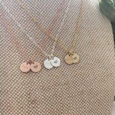 This beautiful dainty necklace features 2 of our Mini discs, 1 to contain a date, initial or (short) name/word of your choice, and the other is a disc with a love heart symbol. Mini Disc measures 9mm. 16", 18", 20" lengths with spring ring clasp. 14k Gold filled, 14k Rose gold filled or Sterling Silver. Available only in 1.5mm Tiny Block font. Handcrafted in Australia. Each piece is hand stamped & there may be slight variations such as with the letter alignment or spacing - this is not a defect Dainty Personalized Round Pendant Heart Necklace, Dainty Stamped Charm Necklaces For Mother's Day, Minimalist Double Heart Personalized Charm Necklaces, Everyday Round Disc Charm Necklace For Mother's Day, Dainty Hand Stamped Round Charm Necklace, Dainty Round Hand-stamped Charm Necklace, Everyday Mother's Day Charm Necklace With Round Disc, Personalized Round Pendant Heart Necklace For Everyday, Dainty Hand-stamped Round Charm Necklace