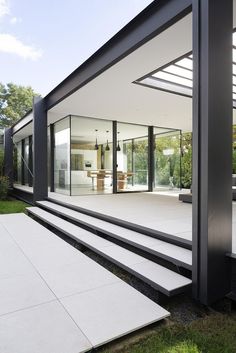 a modern house with glass walls and stairs