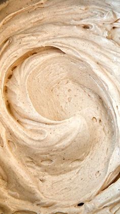 a bowl filled with white frosting sitting on top of a table