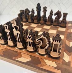 a wooden chess board with carved pieces on it and an intricately designed piece in the middle