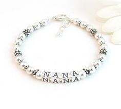 Beaded Name Bracelet: Created with 4.8mm sterling silver alphabet blocks, 5mm sterling silver balls, and handcrafted sterling silver accent beads.  The name on the bracelet can be hers, her child or grandchild's name, or something like Nana, Mimi, Grandma, Mommy, etc. The beads are strung on super strong, stainless-steel wire for extra durability. Note: the handcrafted accent beads may vary (The Gigi bracelet and video shows the most current stock) The base price includes 6 letters.  Each additi Mimi Grandma, Beaded Name Bracelet, Mom Bracelet, Twisted Heart, Silver Beaded Bracelet, Alphabet Blocks, Sterling Silver Bead Bracelet, Moms Bracelet, L Alphabet