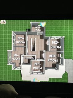 a computer screen showing a floor plan for a house on the tv set in front of a green wall