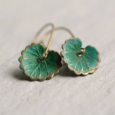 These leaf earrings are brass charms with some amazing detail, which have been carefully treated, painted and varnished to bring out beautiful tones and depth of colour! They look like beautiful watercoloured lily pads! Each leaf is 15mm long (about the size of a thumbnail) and are available in two Bohemian Green Leaf-shaped Jewelry, Green Brass Earrings Nature-inspired, Elegant Green Patina Earrings, Green Brass Drop Earrings, Nature-inspired Green Brass Jewelry, Delicate Handmade Green Jewelry, Handmade Delicate Green Jewelry, Green Brass Earrings As Gift, Green Brass Earrings For Gift