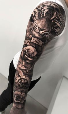 a man's arm with a tiger and roses tattoo on the left sleeve,