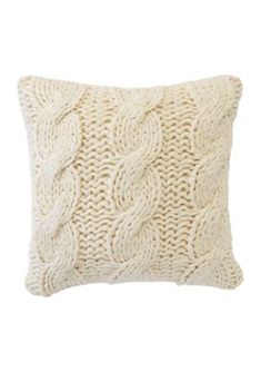 a white knitted pillow on a white background