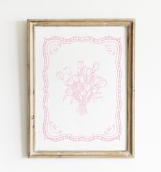 a pink and white drawing of flowers in a frame on the wall next to a shelf