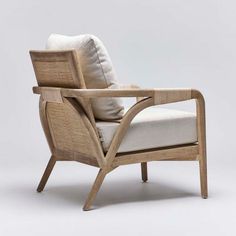 the chair is made out of wood and has white cushions