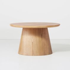 a wooden table sitting on top of a white floor