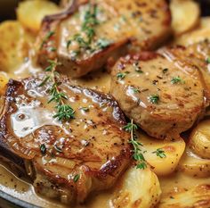 some meat and potatoes are in a skillet with gravy on the side