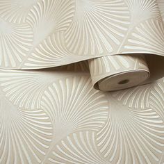 the wallpaper is white and has an intricate design on it, as well as a roll of paper