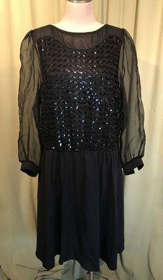 This is a chic vintage, dress from the 60s or 70s. It has a label that reads, "Boston Maid".  No size tags.  The bust measures 44", see measurements below.  The front bodice is covered in rows of sequins, the shoulders & sleeves are sheer & the skirt is semi-sheer & plain black. It is not lined.  It has long sheer sleeves with narrow , solid button cuffs. It has string belt loops at the waist & one is hanging by a thread.  Slips over the head & zips in back with a nylon zipper. The dress is in good vintage condition. No soil or stains. Minimal wear, missing belt.  So chic!  Measurements were taken with the garment laying flat. If you have never worn vintage before, please measure yourself!! Vintage sizes run smaller than today's sizes, you need to know your measurements! If you have any qu Retro Black Cocktail Dress, Knee-length Vintage Dress For Fall Party, Black Retro Party Dress, Retro Black Party Dress, Retro Knee-length Dresses For Date Night, Retro Evening Dress For Fall, Retro Party Dress For Fall, Fall Party Vintage Midi Dress, Retro Fall Party Dress