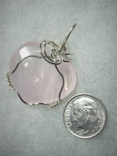 Rose Quartz Heart Pendant Wire Wrapped in .925 Sterling Silver Round Wire This radiant light pink translucent stone heart makes a delightful enhancement when worn with pink, purple or red clothing, elegant with many other colors as well. The heart shape, rather consistent color, and minimal pattern, should appeal to the purist view; artistic appeal may be found in the internal crystal plane and partially cloudy interior. Description: Soft light pink, heart shaped, translucent stone wrapped in 20 Pink Round Pendant With Heart Charm, Pink Round Pendant Jewelry With Heart Charm, Pink Heart Charm Round Pendant Jewelry, Pink Heart Beads Jewelry For Anniversary, Pink Round Jewelry With Heart Charm, Pink Jewelry With Heart Charm, Pink Heart-shaped Gemstone Jewelry, Nickel-free Pink Heart Cut Jewelry, Pink Round Jewelry For Valentine's Day