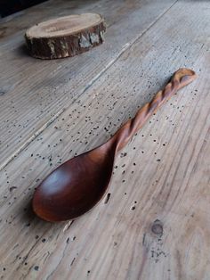 a wooden spoon sitting on top of a wooden table