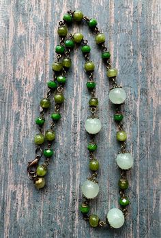 A beautiful beaded necklace. I love the shades of green that looks good together. Beads are made of glass.  Necklace is 10 inch long. Green Jade Beaded Chain Jewelry, Green Jade Jewelry With Beaded Chain, Green Glass Round Bead Jewelry, Green Beaded Chain Jewelry, Green Gemstone Beaded Necklaces, Green Jade Necklaces With Faceted Beads, Green Jade Necklace With Faceted Beads, Green Czech Glass Jewelry, Elegant Green Czech Glass Beads