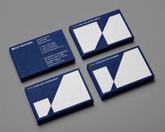 four business cards on top of each other with white and blue designs in the middle