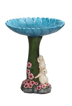 a blue flower vase with a white bunny in the center and pink flowers around it