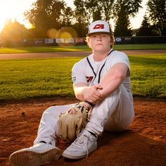 a baseball player is sitting on the ground