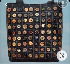 a black bag with buttons on it and a white button in the bottom right corner