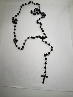 Gorgeous black beaded rosary inspired by vampires.  Black enamel alloy bat, black alloy roses and a stainless steel gunmetal colour anhk completes this look.  Please note all my rosaries are extra long to suit different body types and shapes and gives you the option to do a revolution around your neck for a layered look.  This rosary is on the smaller end compared to the other rosaries i have on site.  It will be great on its own or layered with a long rosary like Nancy Downs.  Please ask any qu Black Vampire Jewelry For Festival, Vampire Style Black Jewelry For Festivals, Black Gothic Jewelry With 8mm Beads, Black Beaded Cross-shaped Rosary, Black Beaded Cross Rosary, Nancy Downs, Belly Conklin, Black Vampire, Rosary Style Necklace