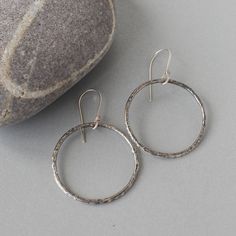 "Reticulated sterling silver hoop style earrings, perfect for every day or a fun night on the town.   The process takes patience, time and a bit of luck.  The textures in this earrings, often referred to as \"reticulation\" occur when you heat and cool the metal a number of times until you achieve a pure layer of silver on the top at which point the beautiful textures start to appear.. the challenge with this process is that if you overheat the silver .. you end up with a puddle of silver.    Material: Sterling Silver Size: 2\" from top of ear wire to the bottom of the circle" Artisan Small Hoop Earrings For Everyday, Oxidized Circle Hoop Earrings As Gift, Artisan Hoop Earrings With Ear Wire For Everyday, Modern Oxidized Hoop Earrings For Everyday, Gift Circle Hoop Earrings With Oxidized Finish, Modern Oxidized Finish Hoop Earrings For Everyday, Everyday Small Hoop Earrings With Oxidized Finish, Hand Forged Sterling Silver Hoop Earrings For Everyday, Everyday Silver Oxidized Hoop Earrings