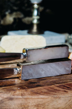 two different types of cheese sitting on top of a wooden table