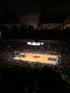 a basketball game is being played in an arena