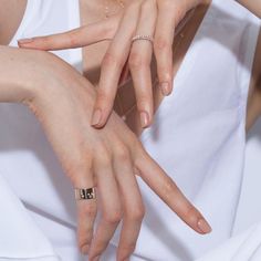 two hands touching each other with their fingers on top of the woman's dress