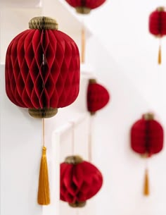 red paper lanterns hanging from the ceiling with tassels