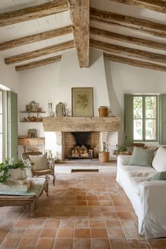 a living room filled with furniture and a fire place in the middle of a room