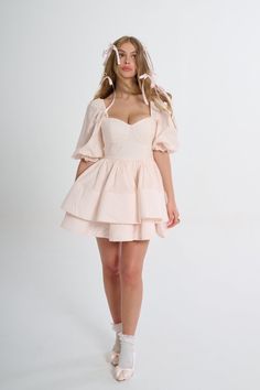 Glide through the day with elegant ease in the Lickety Split Vacation Dress. You’ll fall in love with its romantic sweetheart neckline, billowy puff sleeves, and structured tiered skirt. The color is the palest pink of satin pointe shoes and the flouncy double tiers that evoke flower petals. Pack this for a romantic weekend getaway: twirl through flower conservatory, toast at a wine tasting, and then share fresh pastas at a tiny Italian restaurant. Underwire cups Puff sleeves Two layers of offse Silk Dressing Gown, Corset Skirt, Puff Dress, Vacation Dress, Pointe Shoes, Knitted Coat, Vacation Dresses, Gathered Skirt, Tiered Skirt