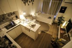 an aerial view of a kitchen and living room in a small apartment with wood flooring