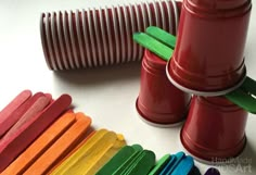 several popsicle sticks are arranged in the shape of a rainbow